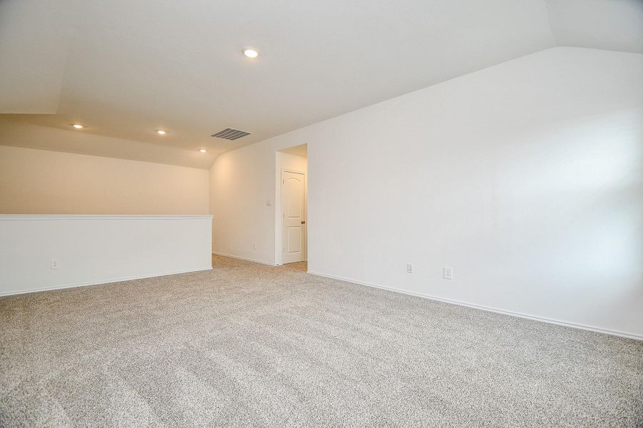 This photo shows a spacious, well-lit room with neutral carpeting, recessed lighting, and clean white walls, ideal for a versatile living area or office space. This photo shows a spacious, well-lit room with neutral carpeting, recessed lighting, and clean white walls, ideal for a versatile living area or office space.