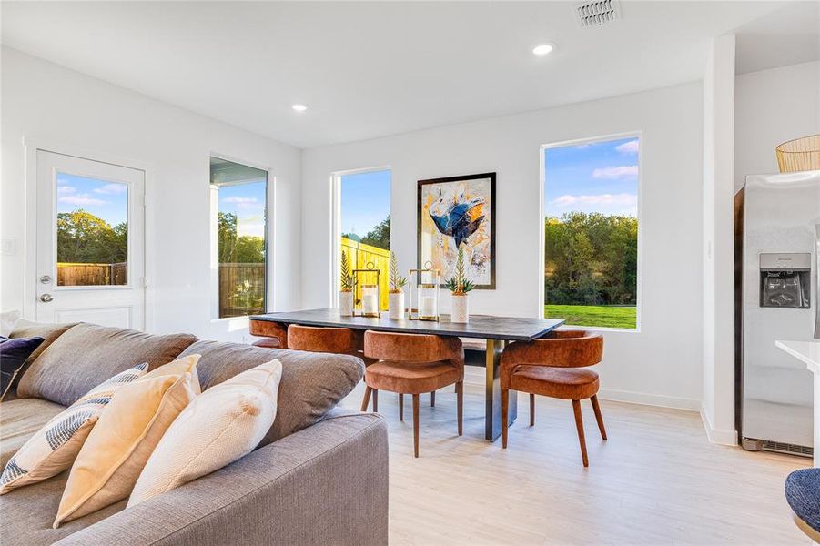 Dining space featuring baseboards, light wood finished floors, visible vents, and recessed lighting