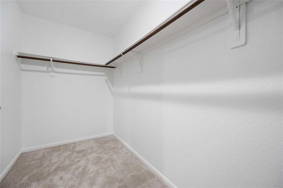 Huge walk-in closet off the primary ensuite bathroom.