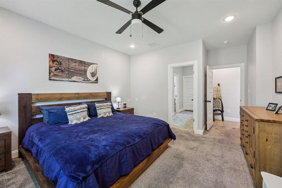 Bedroom with carpet flooring, recessed lighting, and a ceiling fan Bedroom with carpet flooring, recessed lighting, and a ceiling fan