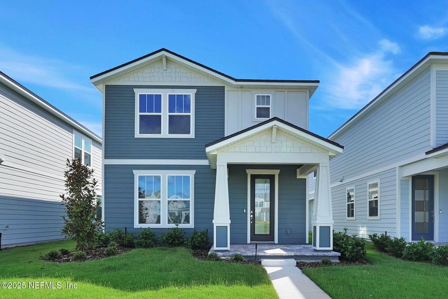 Front exterior of a new home in Hawthorn Park at Wildlight, Yulee, FL, highlighting curb appeal (Image 2).