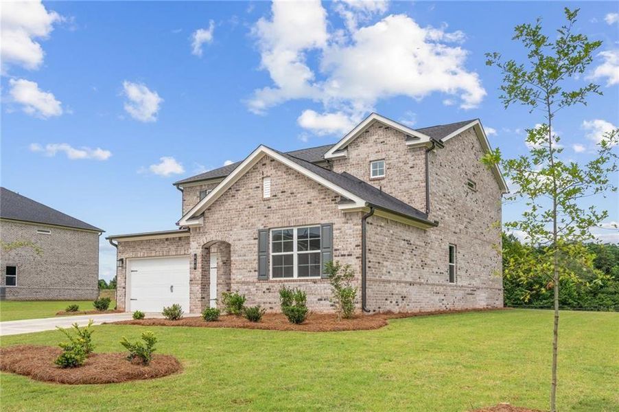 Front exterior of a new home in Walker Grove, McDonough, GA, highlighting curb appeal (Image 2). Front exterior of a new home in Walker Grove, McDonough, GA, highlighting curb appeal (Image 2).