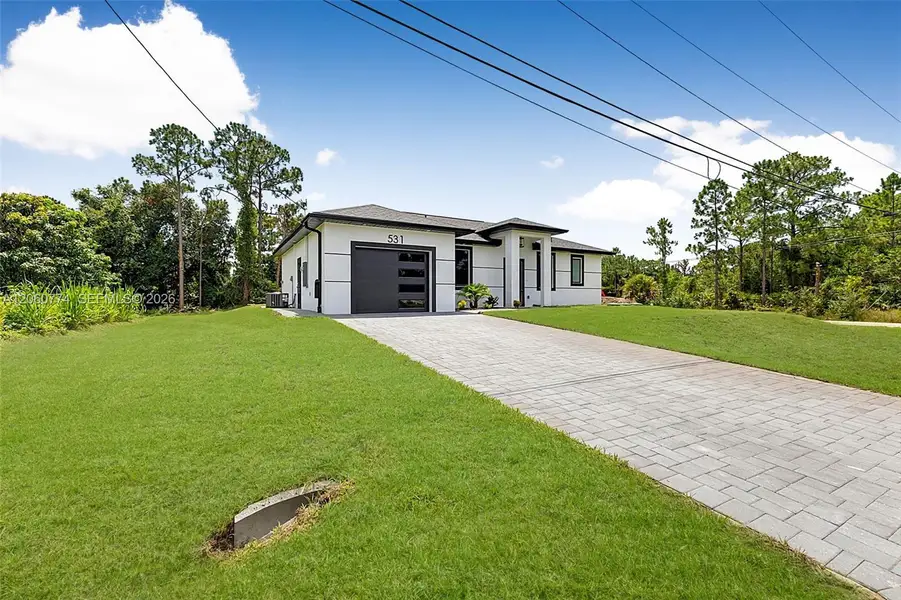 Front exterior of a new home in , Lehigh Acres, FL, highlighting curb appeal (Image 21). Front exterior of a new home in , Lehigh Acres, FL, highlighting curb appeal (Image 21).