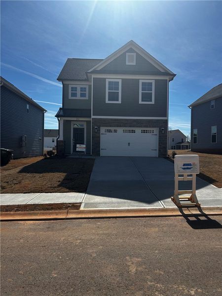 This newly constructed home presents a contemporar