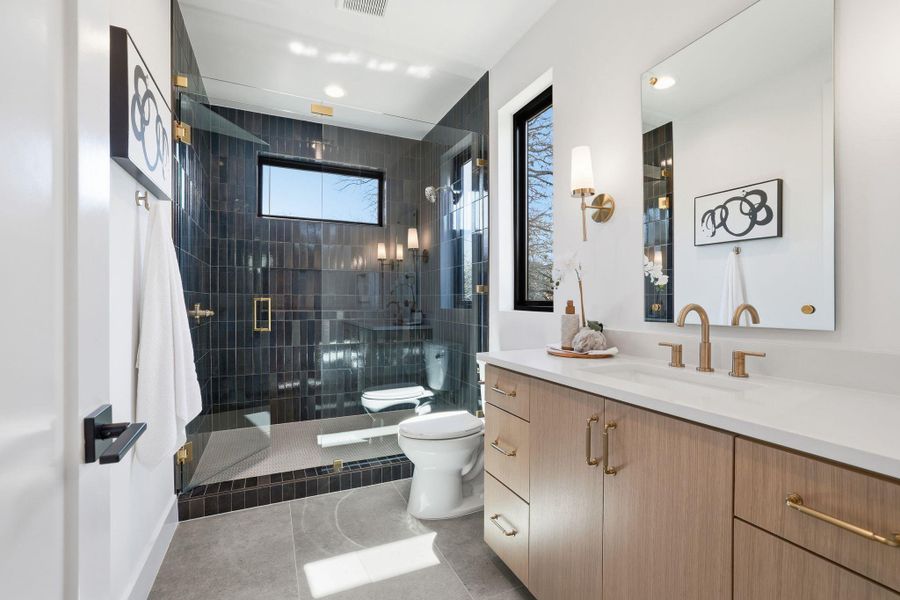 Full bathroom featuring walk in shower, vanity, light tile patterned floors, and a bidet
