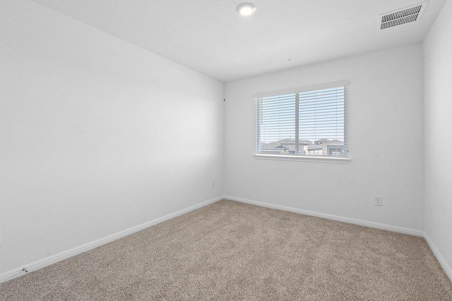 Unfurnished room with carpet and baseboards Unfurnished room with carpet and baseboards