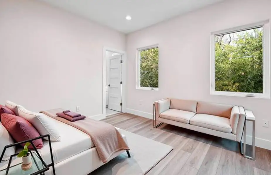 Bedroom featuring light wood finished floors and recessed lighting Bedroom featuring light wood finished floors and recessed lighting