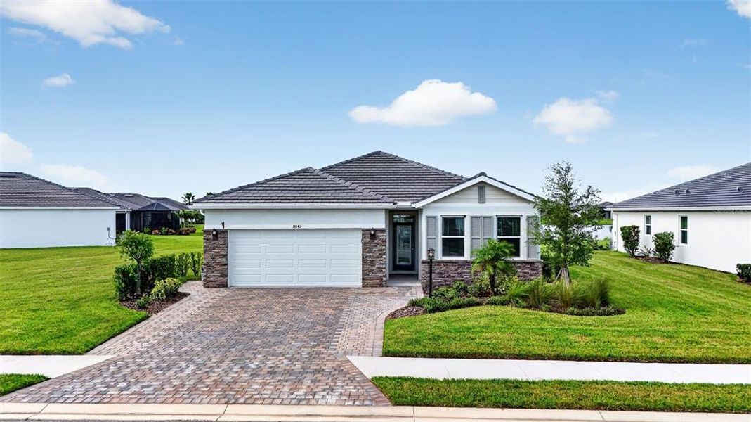 Front exterior of a new home in Star Farms at Lakewood Ranch, Bradenton, FL, highlighting curb appeal (Image 1). Front exterior of a new home in Star Farms at Lakewood Ranch, Bradenton, FL, highlighting curb appeal (Image 1).
