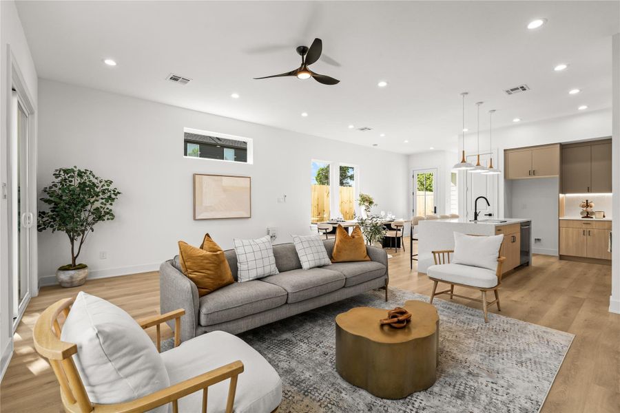 This view shows just how spacious the open-concept living area is. The layout easily fits a large sofa and accent chairs, keeping the living room, dining area, and kitchen completely connected and open.