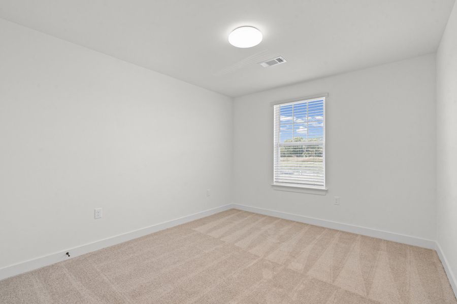 Neutral wall paint, window with blinds, overhead flush mount light fixture, and carpeted flooring
