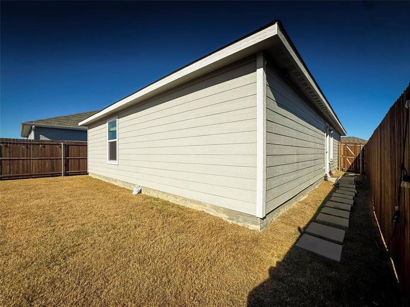 View of side of home featuring a fenced backyard