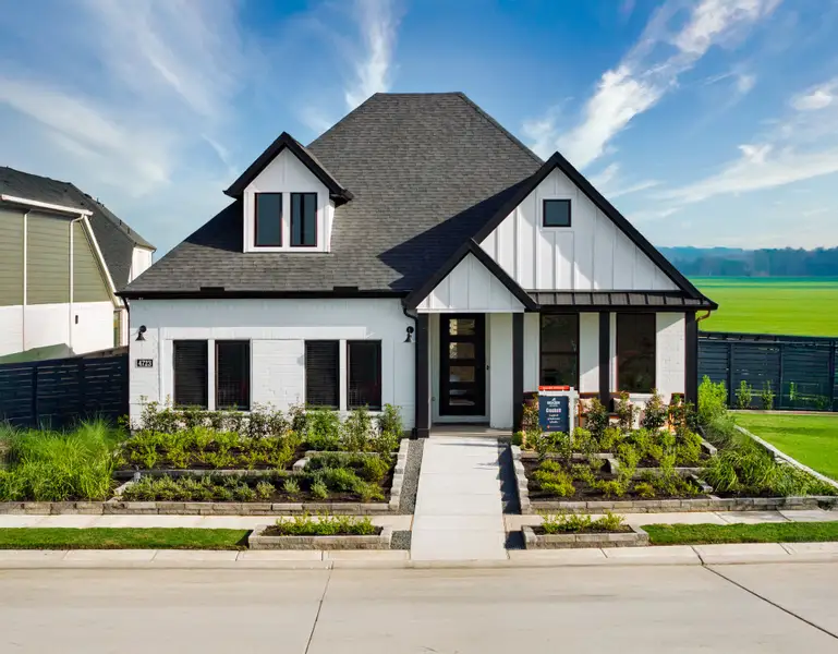 Front exterior of a new home in Austin Point, Richmond, TX, highlighting curb appeal (Image 2).