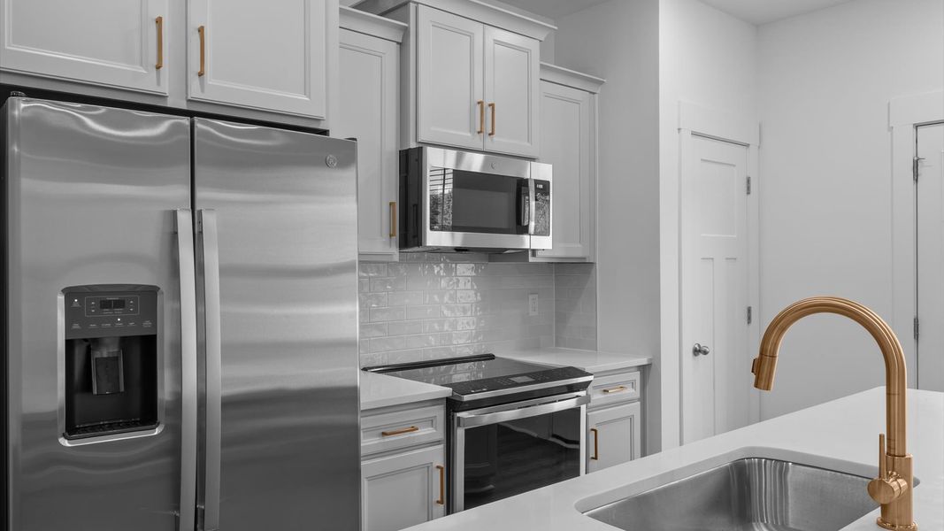 Superior craftsmanship shines in this modern kitchen with a space-saving island and open flow near Downtown Simpsonville