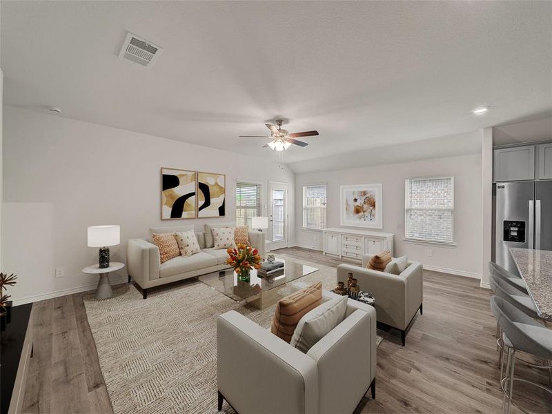 Living room featuring light wood-type flooring, visible vents, ceiling fan, and baseboards