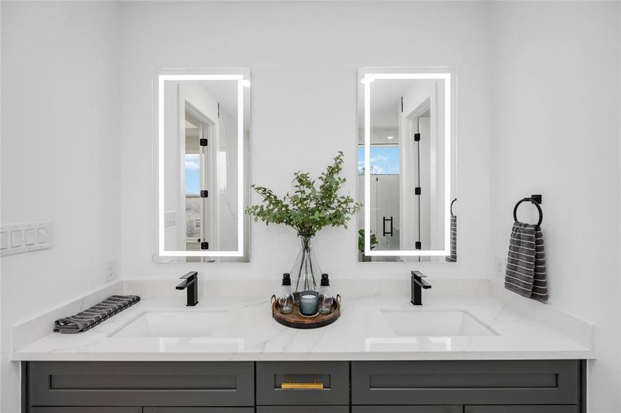 Elegant primary ensuite bathroom with dual vanities