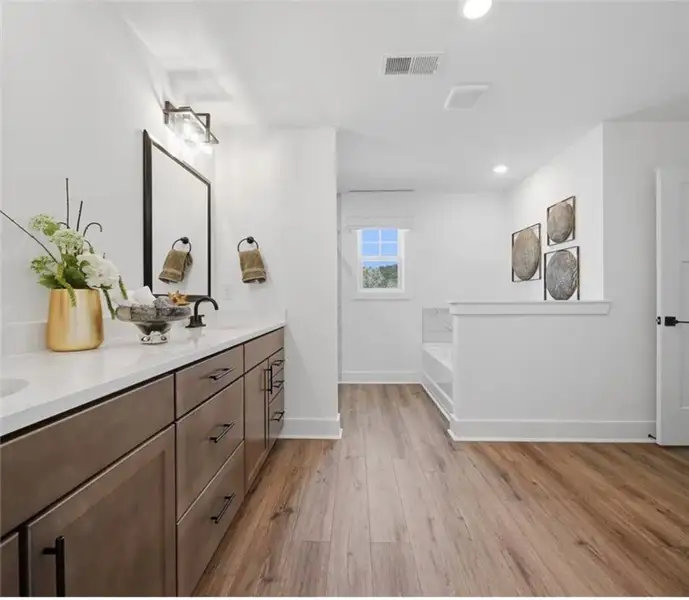 A well-appointed bathroom features dual vanities a A well-appointed bathroom features dual vanities a