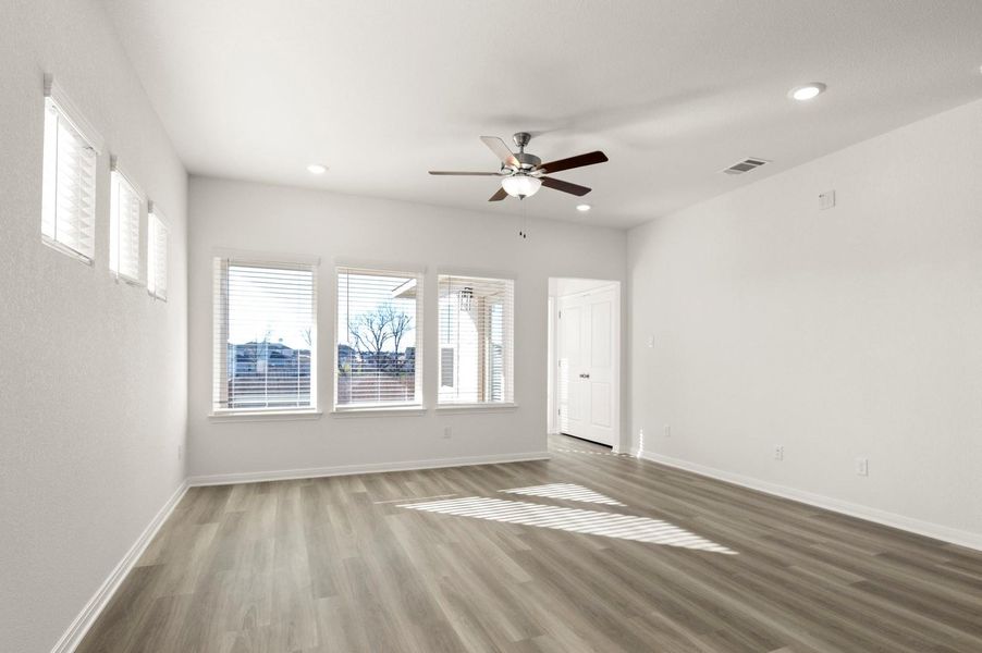 Empty room featuring wood finished floors, a ceiling fan, and recessed lighting