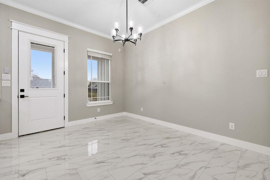 Dining room with door leading to covered back porch. Dining room with door leading to covered back porch.