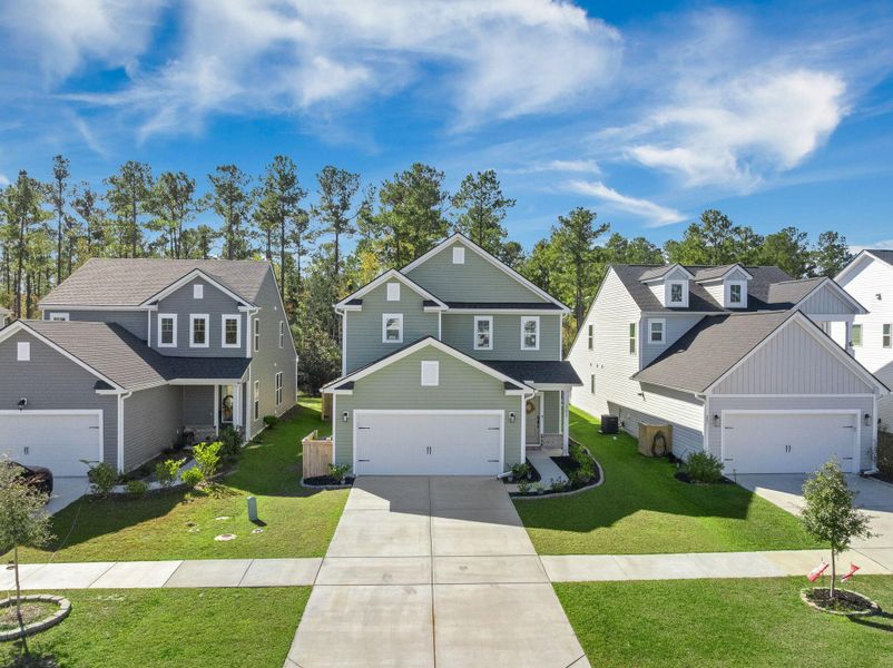 Front exterior of a new home in Jasmine Point at Lakes of Cane Bay, Summerville, SC, highlighting curb appeal (Image 27).