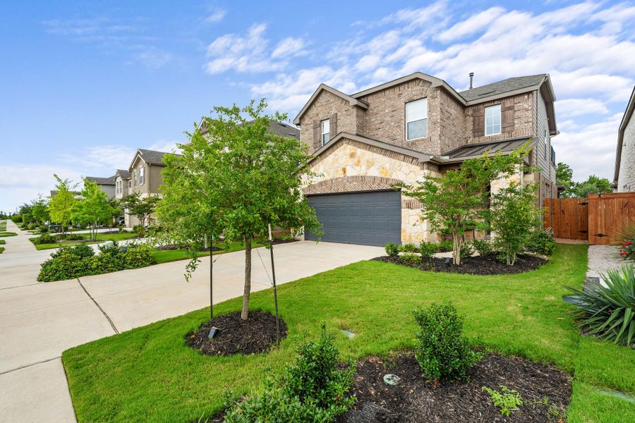 A well-maintained lawn and mature landscaping enhance this inviting suburban home with a two-car garage. A well-maintained lawn and mature landscaping enhance this inviting suburban home with a two-car garage.