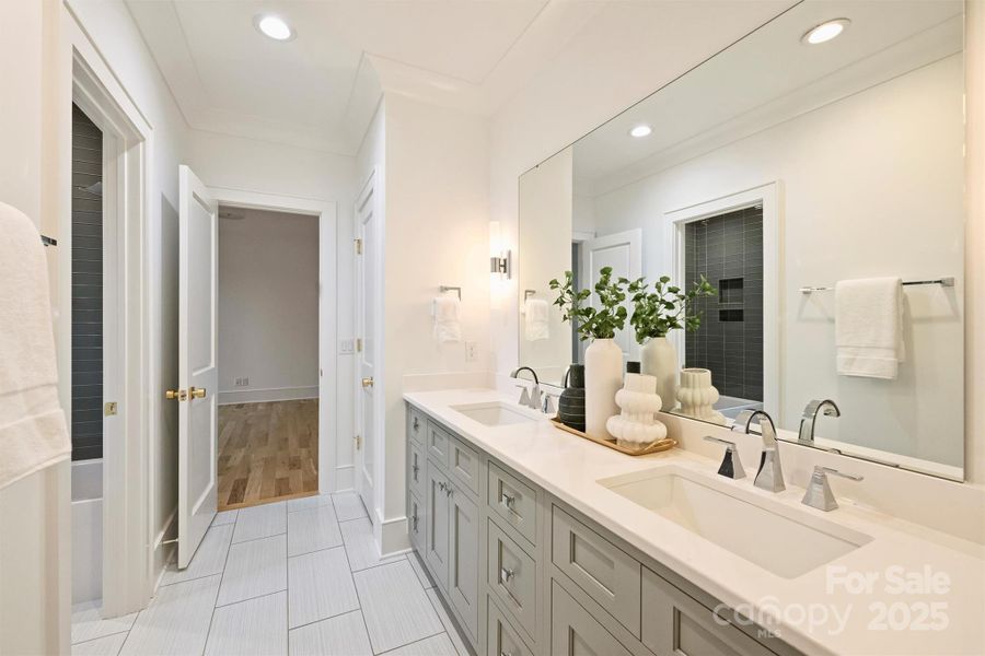 Third full bath on the second level featuring quartz countertops and designer light fixtures.