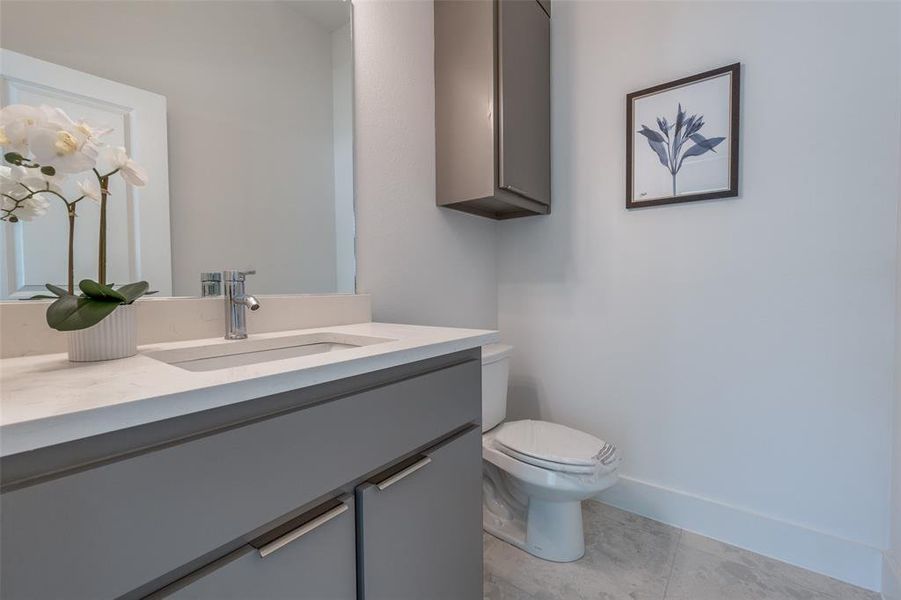 Bathroom featuring tile flooring, toilet, and vanity