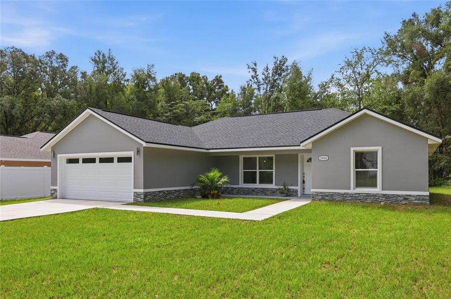 Front exterior of a new home in , Summerfield, FL, highlighting curb appeal (Image 2).
