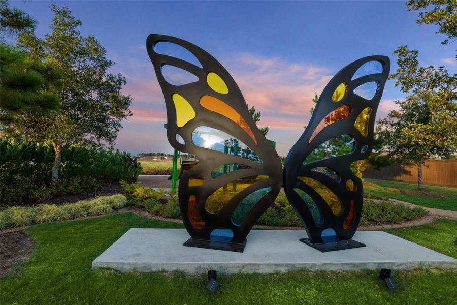 Beautiful community entrance to Harrington Trails at The Canopies in New Caney, TX, showcasing a stone architecture, lush landscaping and serene water features that reflect the charm and quality of this thoughtfully designed neighborhood.