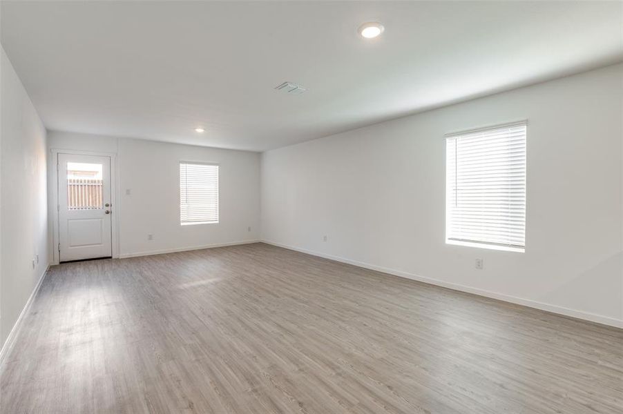 Empty room with light hardwood / wood-style floors