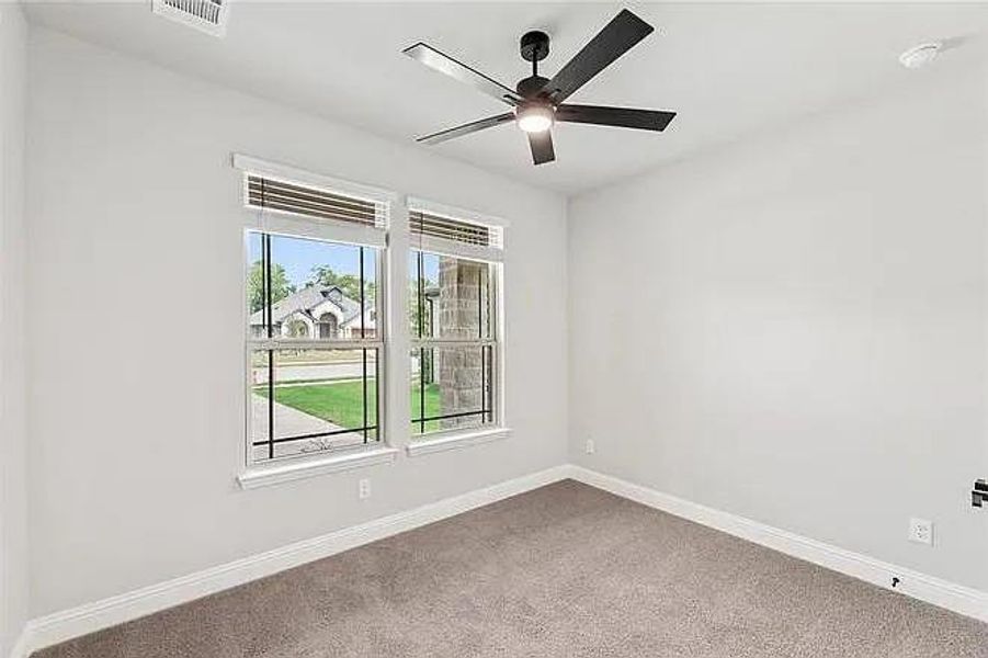 Empty room with carpet floors, ceiling fan, and baseboards
