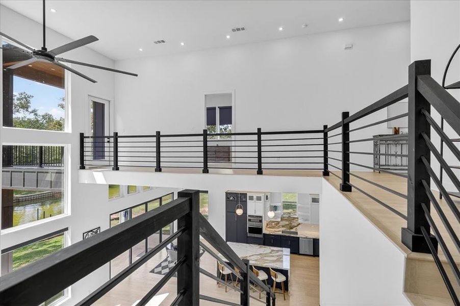 Open upper-level landing overlooks the dramatic main living space below