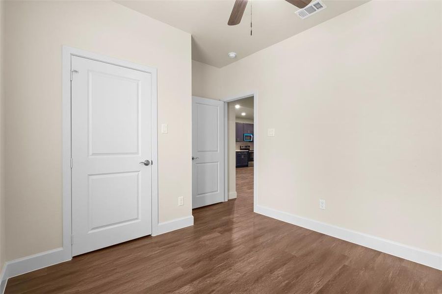 Unfurnished bedroom with hardwood / wood-style floors and ceiling fan