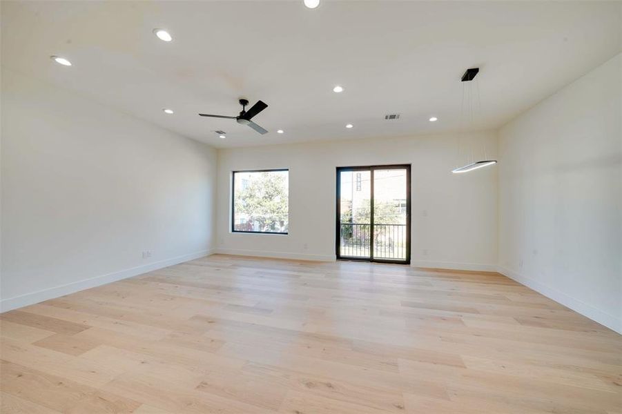 Unfurnished room with ceiling fan and light wood-type flooring