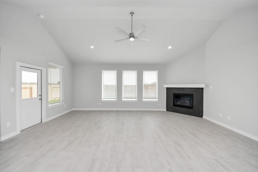 Welcome family and guests to your charming living room! With its high ceilings, recessed lighting, ceiling fan, custom paint, beautiful flooring, and large windows that let in abundant natural light, this room is perfect for gatherings. Sample photo of completed home with similar floor plan. Actual colors and selections may vary. Welcome family and guests to your charming living room! With its high ceilings, recessed lighting, ceiling fan, custom paint, beautiful flooring, and large windows that let in abundant natural light, this room is perfect for gatherings. Sample photo of completed home with similar floor plan. Actual colors and selections may vary.