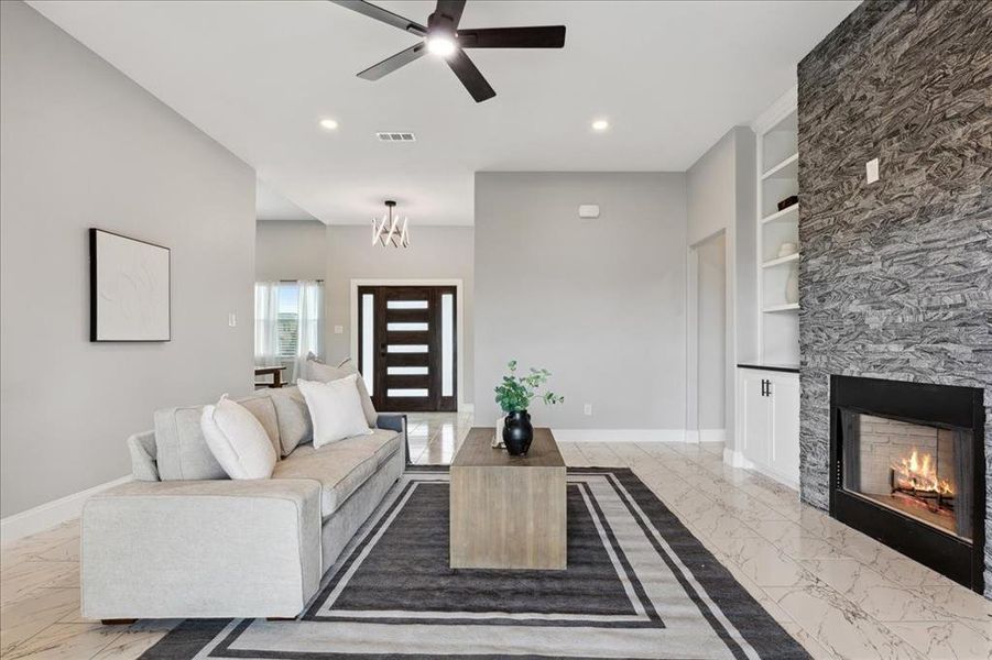 Living room with marble finish floor, visible vents, baseboards, and built in shelves