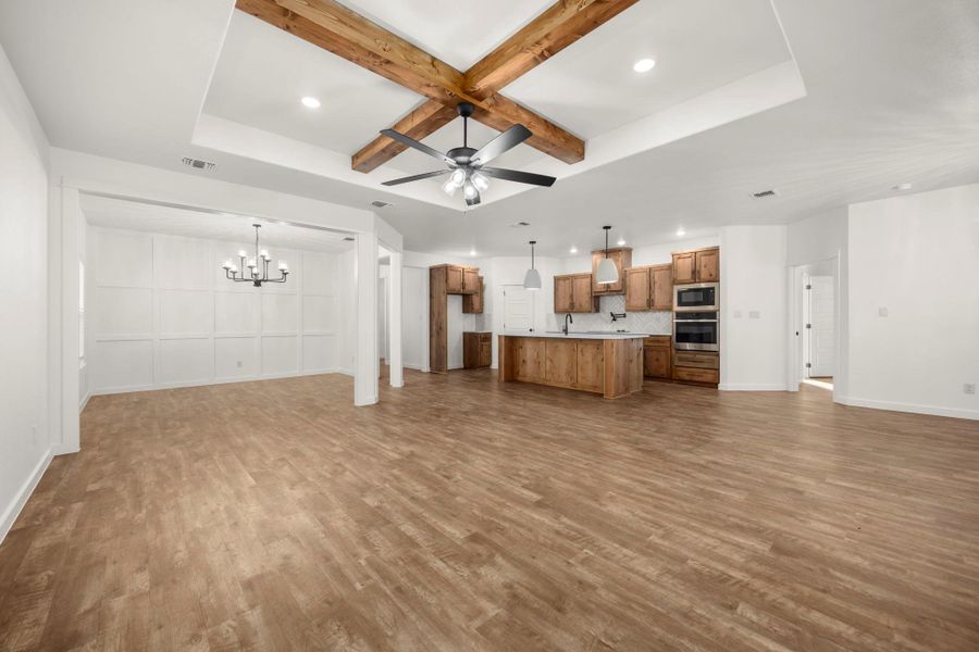 A spacious, airy layout connects the living area, kitchen, and dining space with natural wood accents.