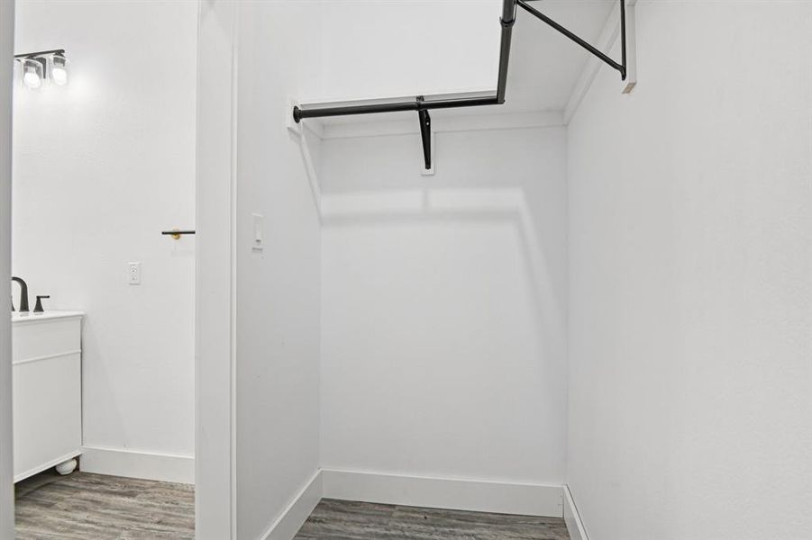 Spacious closet with wood finished floors Spacious closet with wood finished floors