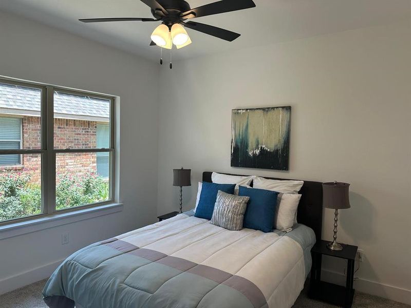 Bedroom featuring carpet and ceiling fan