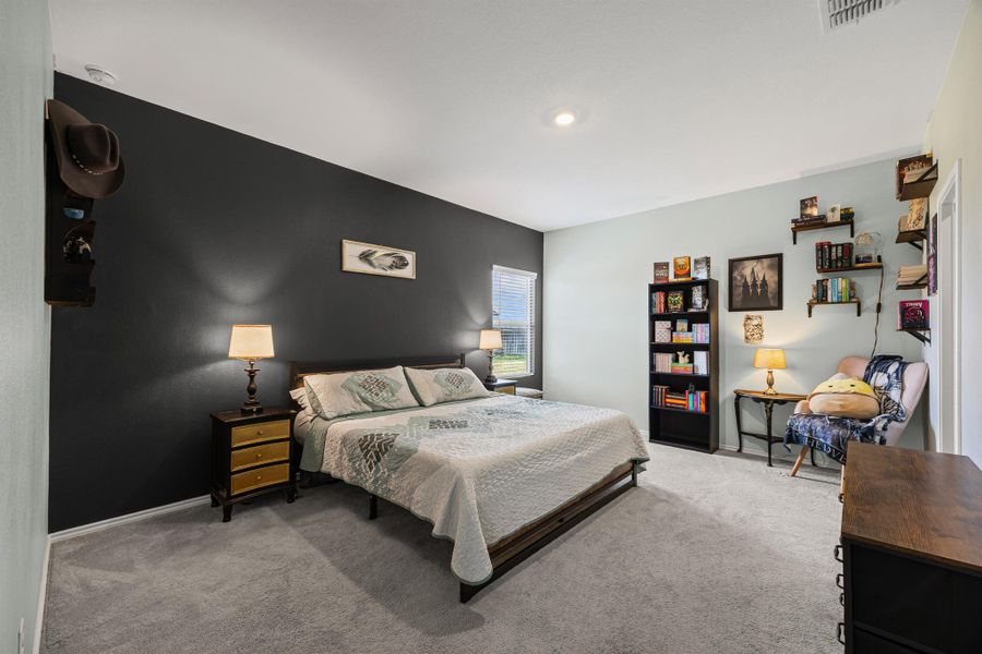 Carpeted primary bedroom featuring baseboards Carpeted primary bedroom featuring baseboards