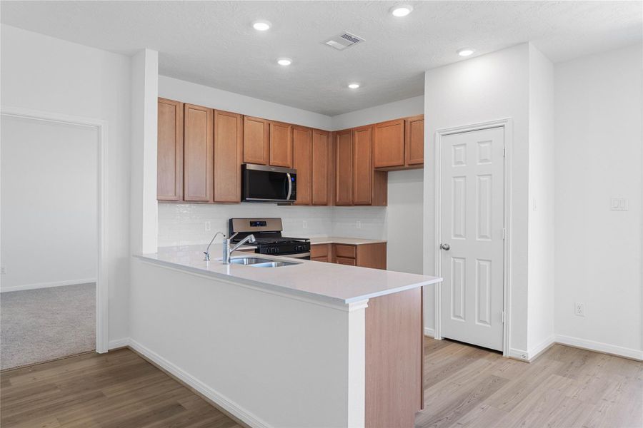 This spacious kitchen has it all—ample storage, generous counter space, and a layout that truly makes it the heart of the home.