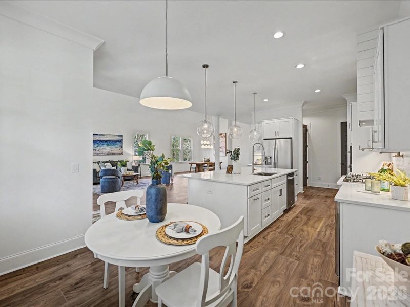 Bright and inviting breakfast area with modern lighting, perfect for casual dining and seamlessly connected to the open-concept kitchen and living space.