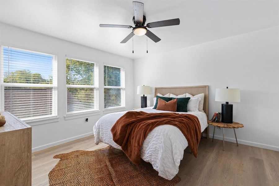 Bedroom featuring ceiling fan and light hardwood / wood-style floors