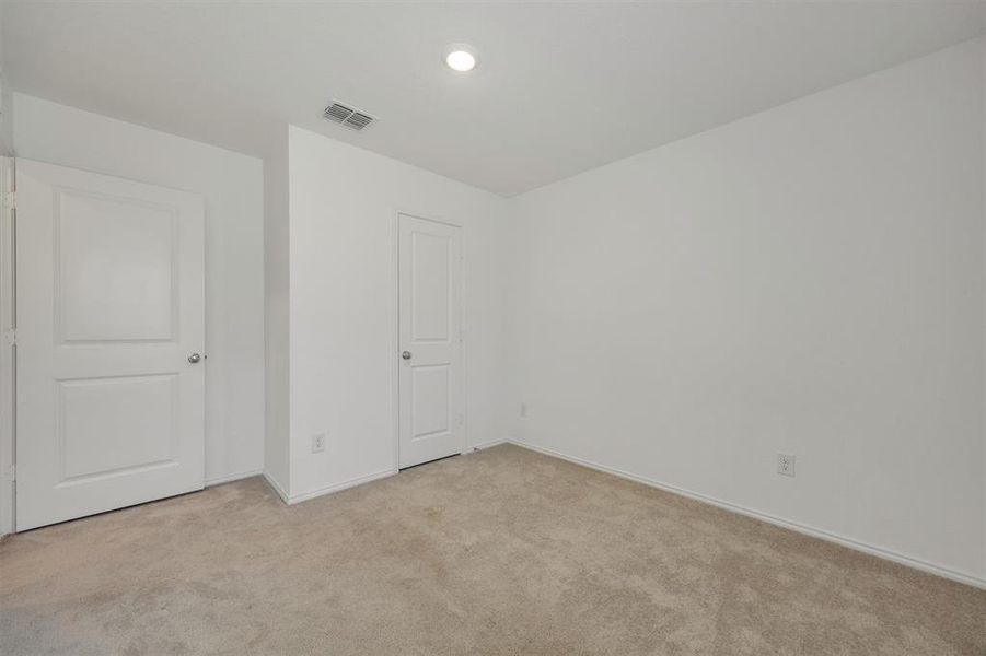 Room featuring neutral carpet flooring, white walls, and a flush-mount ceiling light
