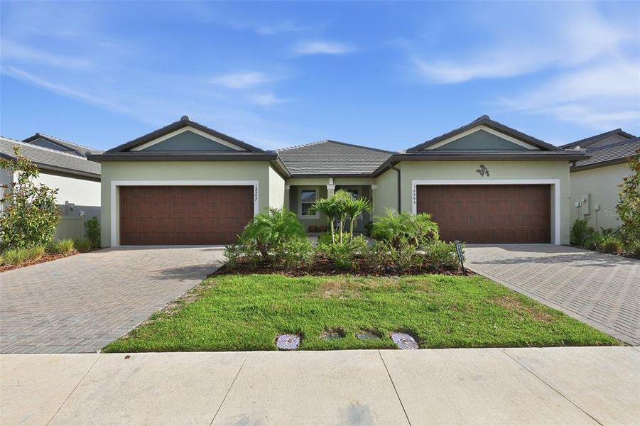 Front exterior of a new home in Prosperity Lakes Active Adult, Parrish, FL, highlighting curb appeal (Image 22).