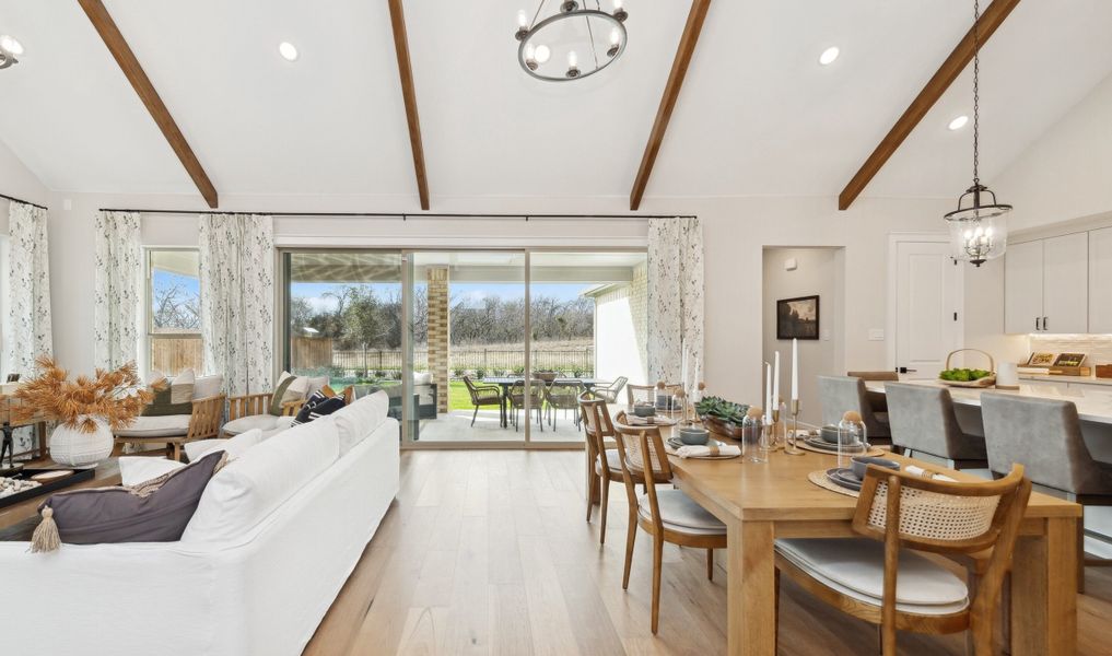 Dining area with vaulted ceiling and stained ceiling beams Dining area with vaulted ceiling and stained ceiling beams