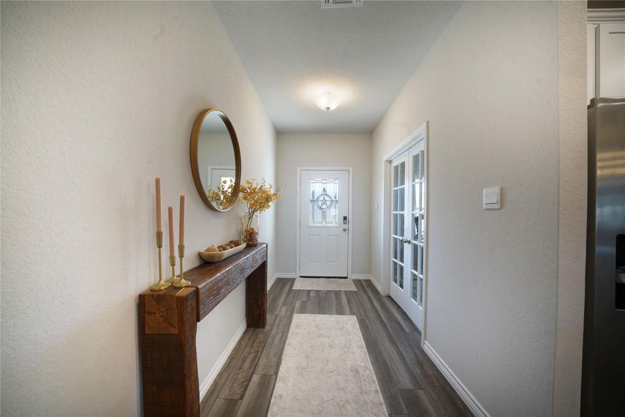 Doorway to outside with baseboards and wood finished floors
