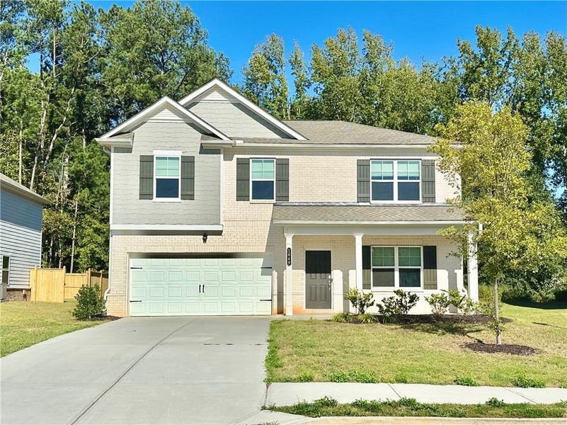 Front exterior of a new home in Watson Farms, Loganville, GA, highlighting curb appeal (Image 2). Front exterior of a new home in Watson Farms, Loganville, GA, highlighting curb appeal (Image 2).
