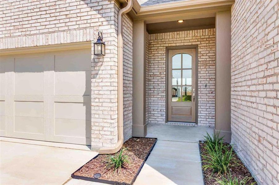Entrance to property with brick siding and roof with shingles Entrance to property with brick siding and roof with shingles