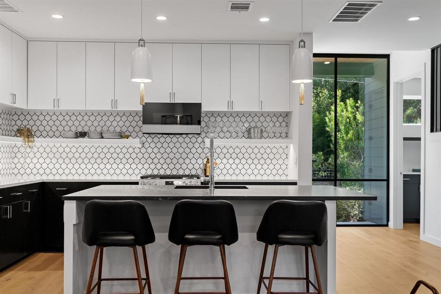 Awesome kitchen with a large center island, tons of storage, and an abundance of light.