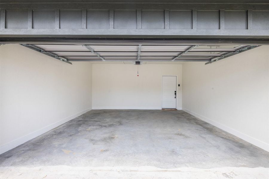 A spacious, newly finished garage offers ample parking and direct interior access. A spacious, newly finished garage offers ample parking and direct interior access.